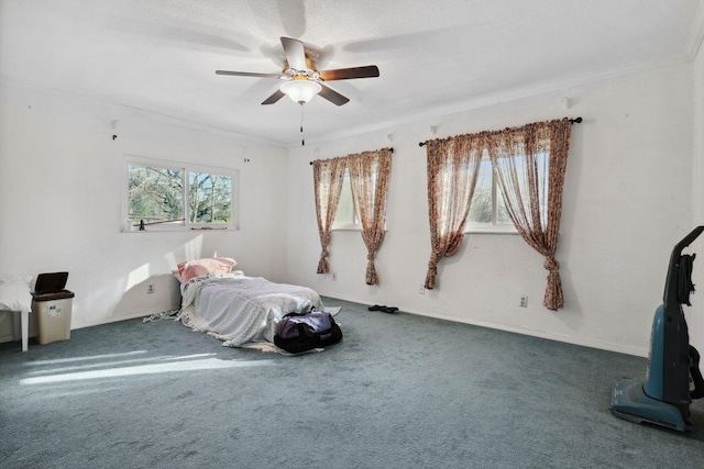 carpeted bedroom with a ceiling fan and ornamental molding