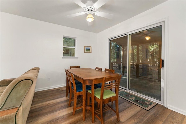 dining space with wood finished floors, a ceiling fan, and baseboards