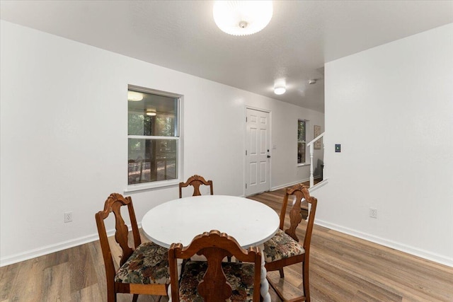 dining area featuring wood finished floors and baseboards