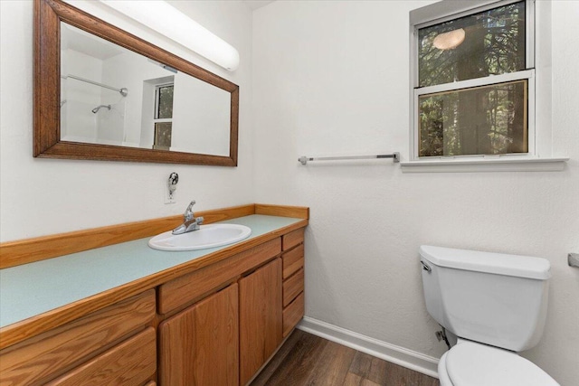 full bathroom with baseboards, vanity, toilet, and wood finished floors