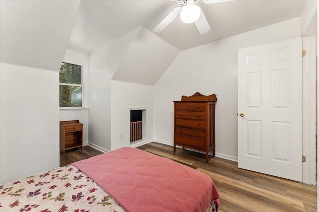 bedroom with lofted ceiling, ceiling fan, baseboards, and wood finished floors