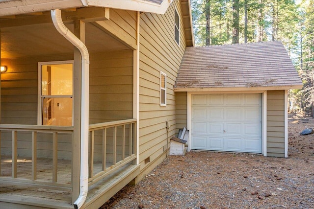 view of home's exterior featuring a shingled roof and a garage