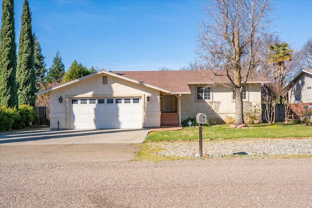 single story home with stucco siding, concrete driveway, an attached garage, a front yard, and fence