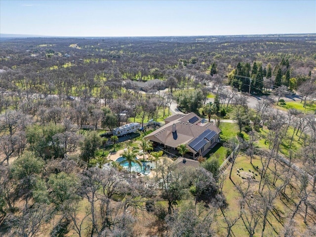 birds eye view of property with a view of trees