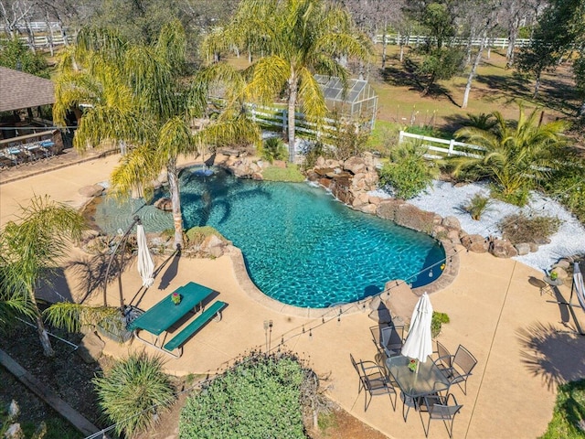 view of pool featuring fence