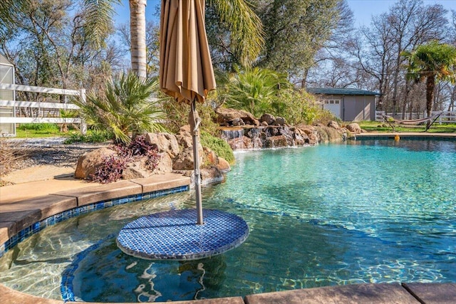 view of pool featuring an outbuilding and a storage shed