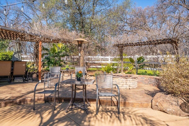 view of patio with outdoor dining area and fence