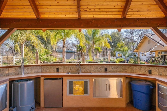 view of patio featuring a sink, a balcony, and area for grilling