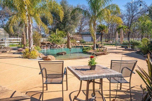 view of community featuring a patio area and a pool