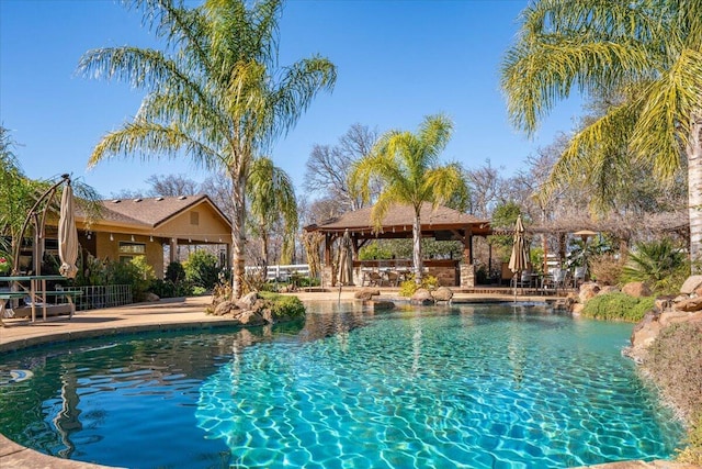 pool with a gazebo and a patio area