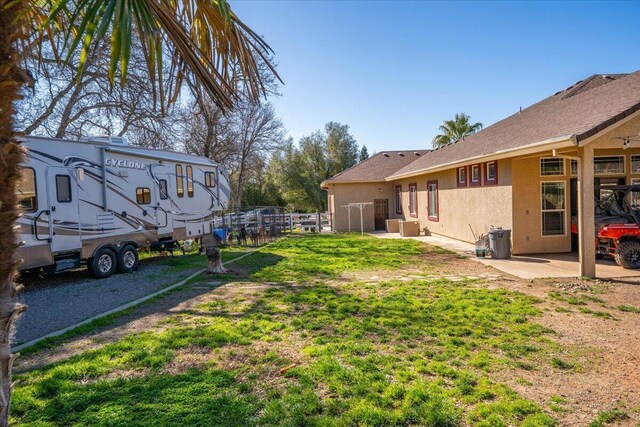 view of yard with fence and a patio