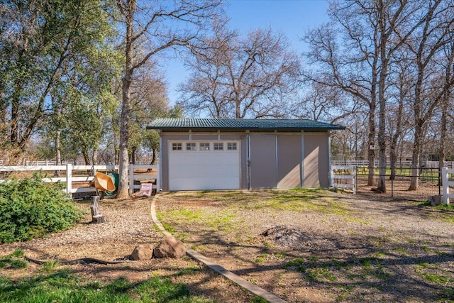 detached garage featuring fence