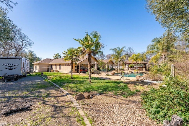 view of yard featuring a patio area, an outdoor pool, and a gazebo