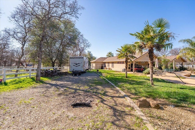 view of front of house with fence and a front lawn