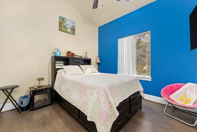 bedroom featuring lofted ceiling, ceiling fan, baseboards, and wood finished floors