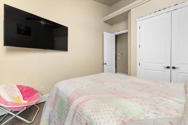 bedroom with a closet and baseboards