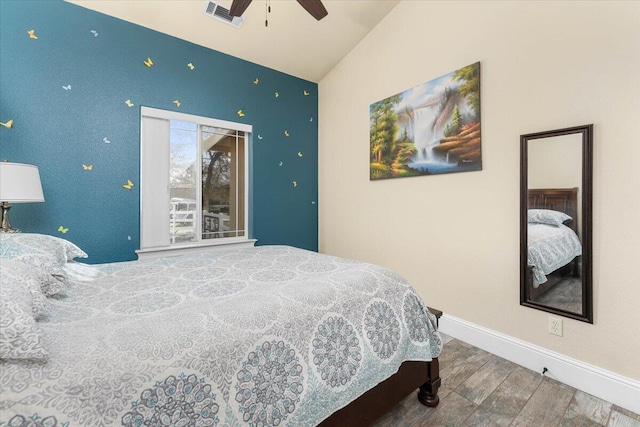 bedroom featuring visible vents, ceiling fan, vaulted ceiling, wood finished floors, and baseboards