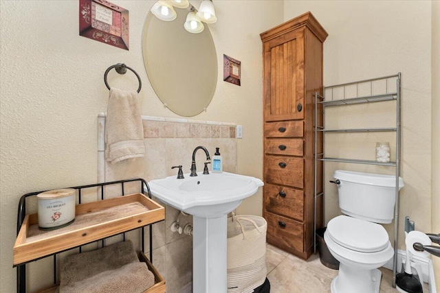 bathroom with tile patterned flooring and toilet