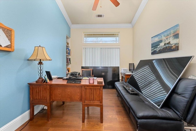 office space with a ceiling fan, visible vents, crown molding, and wood finished floors