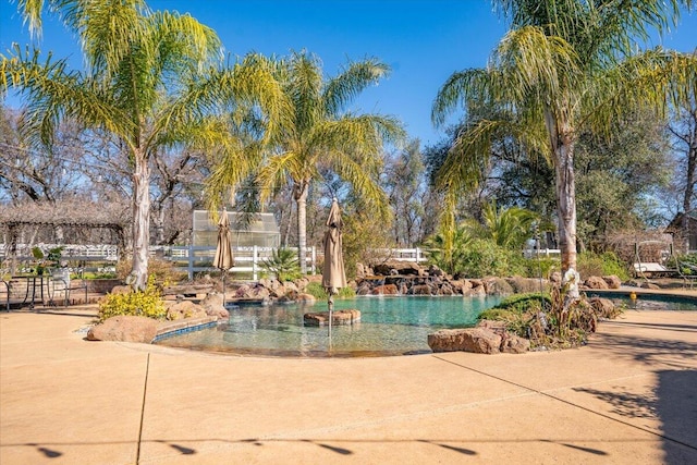 view of property's community featuring fence