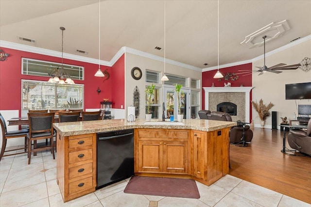 kitchen featuring a fireplace, a sink, visible vents, light countertops, and dishwasher