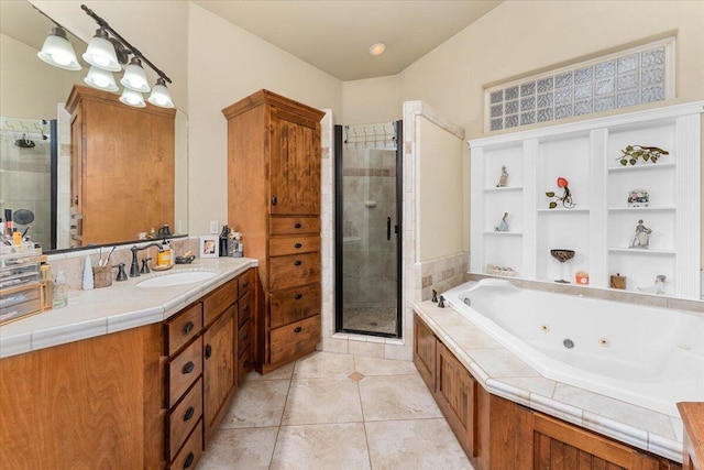 full bathroom with a tub with jets, tile patterned flooring, a shower stall, and vanity