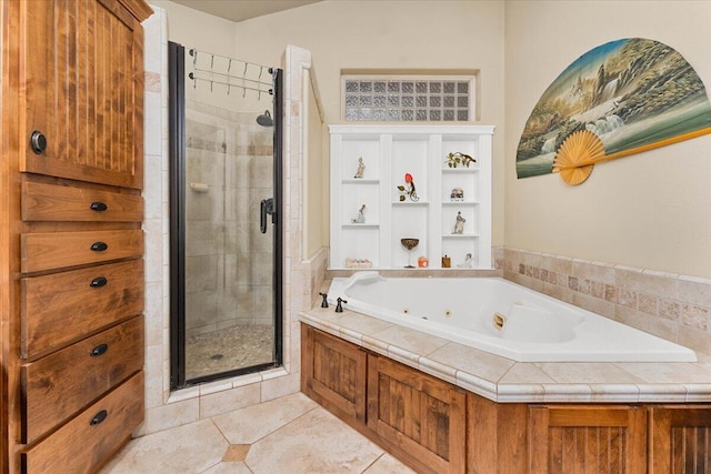 full bath featuring a whirlpool tub, a stall shower, and tile patterned flooring