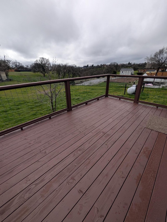 wooden deck featuring a yard