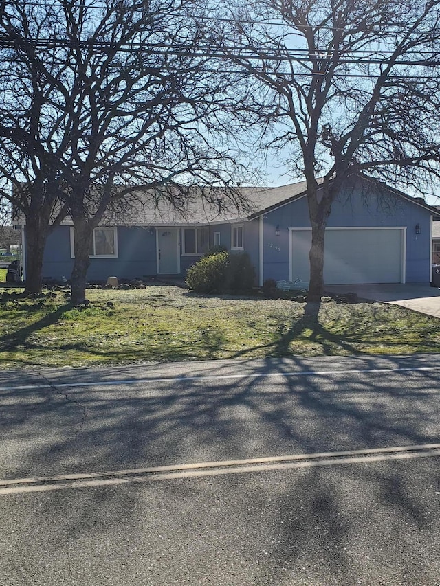 single story home featuring driveway and an attached garage