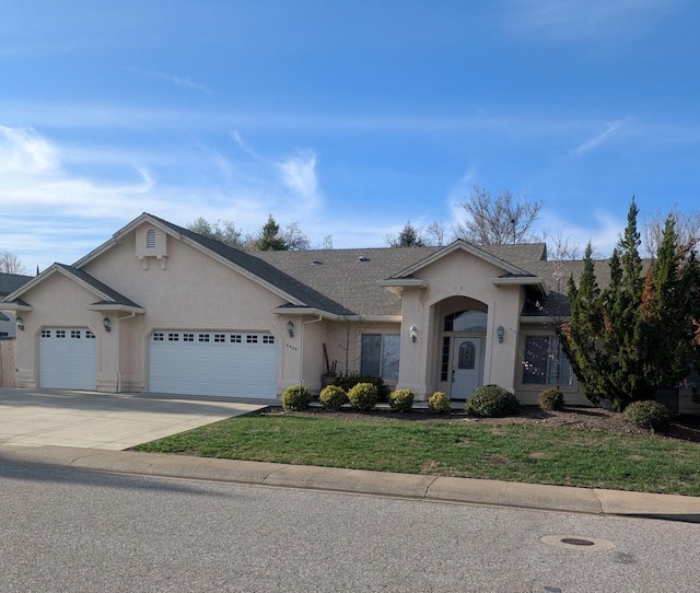 ranch-style home featuring a garage, concrete driveway, and stucco siding