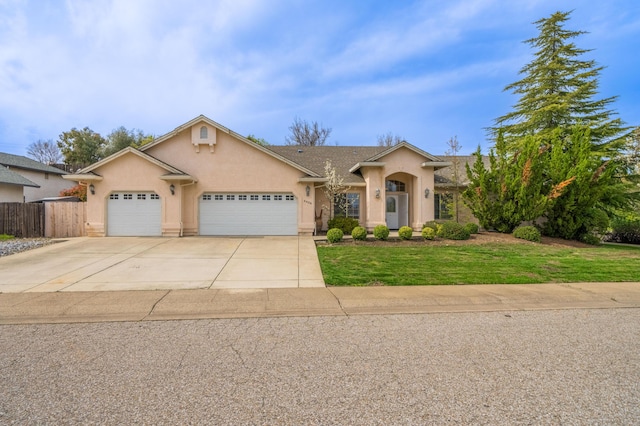 view of front of home featuring stucco siding, fence, driveway, a front lawn, and a garage