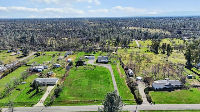 bird's eye view with a wooded view