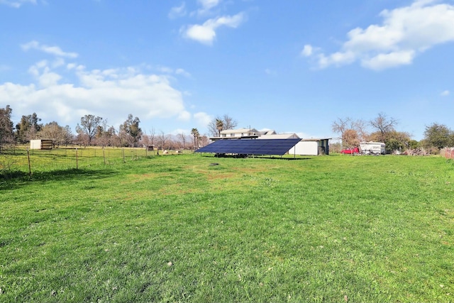 view of yard featuring a rural view and fence