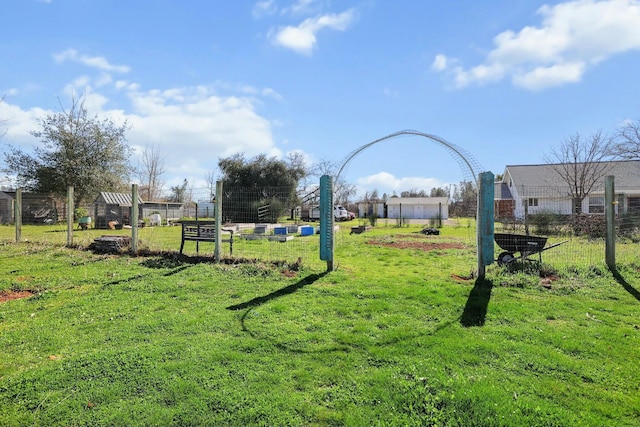 exterior space featuring a lawn and fence