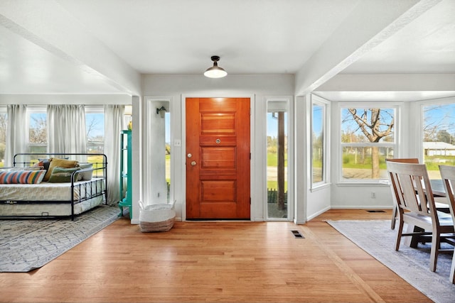 entrance foyer with light wood-style flooring, visible vents, and baseboards