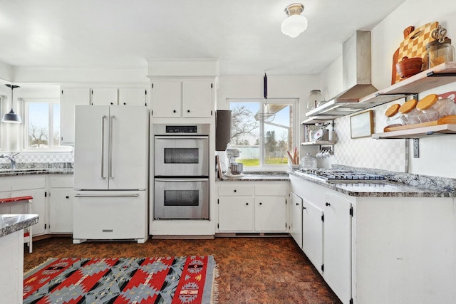 kitchen with open shelves, tasteful backsplash, appliances with stainless steel finishes, and white cabinets