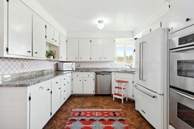 kitchen with ornamental molding, appliances with stainless steel finishes, white cabinets, and tasteful backsplash