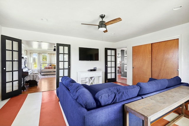 living area featuring french doors, wood finished floors, and a ceiling fan