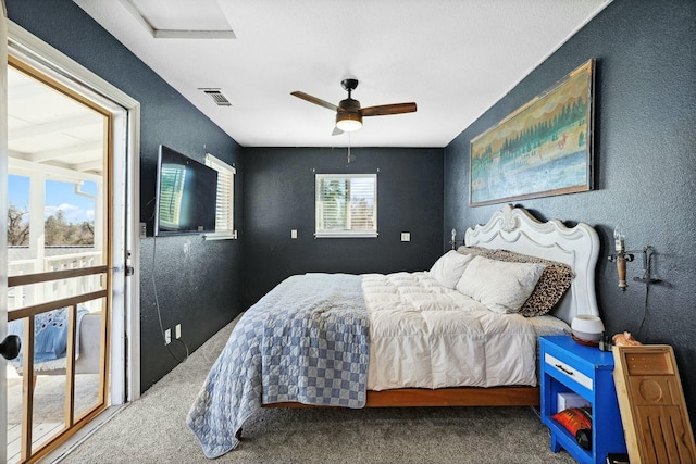 bedroom with a ceiling fan, carpet, visible vents, and a textured wall