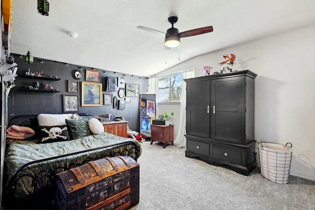 bedroom with lofted ceiling, ceiling fan, a textured ceiling, and light carpet