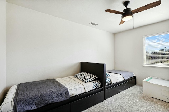 carpeted bedroom featuring visible vents and ceiling fan