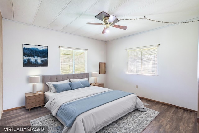 bedroom with a ceiling fan, baseboards, and wood finished floors