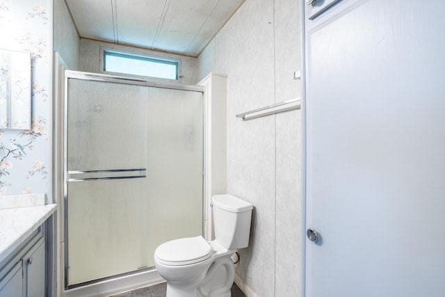 full bath featuring toilet, a stall shower, vanity, and wallpapered walls