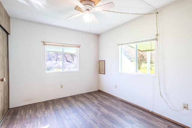 unfurnished room with a ceiling fan, wood finished floors, and a healthy amount of sunlight