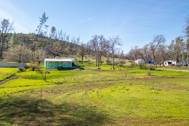 view of yard with an outbuilding and fence