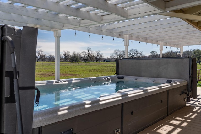 view of swimming pool with a rural view and a hot tub