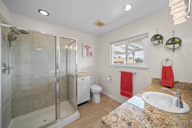 full bath with visible vents, toilet, a stall shower, and vanity