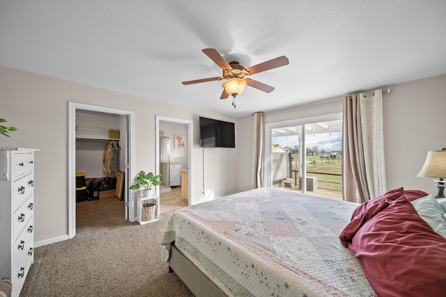 carpeted bedroom with a ceiling fan, baseboards, access to exterior, a walk in closet, and connected bathroom