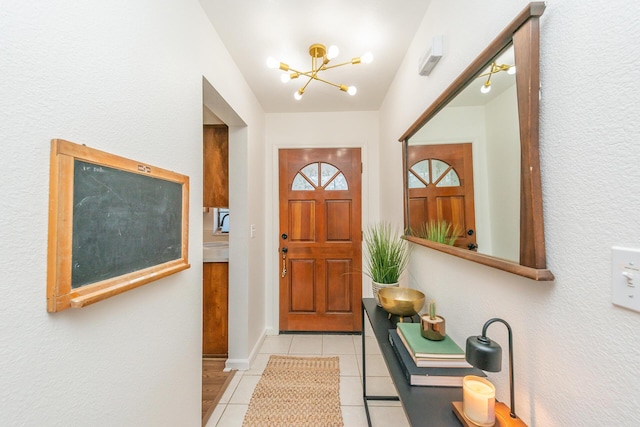 doorway with a chandelier and light tile patterned flooring