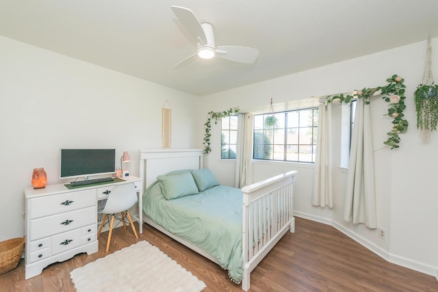 bedroom featuring ceiling fan, baseboards, and wood finished floors